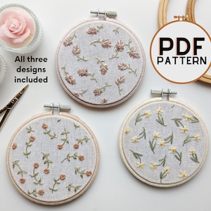 May include: Three embroidery hoop patterns with floral designs. The patterns are for a PDF download. The text "PDF PATTERN" is in the image.