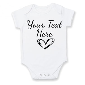 A personalised baby vest in white available in short or long sleeves. Customised text can be applied making it tailored to meet your needs for any occasion. Unique heart icon applied which the design can be applied in any colour of your choice.