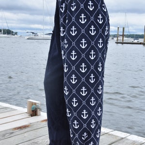 May include: A pair of navy blue lounge pants with a white anchor and rope pattern. The pants are made of a soft, comfortable fabric and are perfect for relaxing at home.