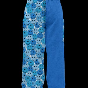 May include: Blue and white patterned pants with a smiley face design on one leg and a solid blue color on the other leg.