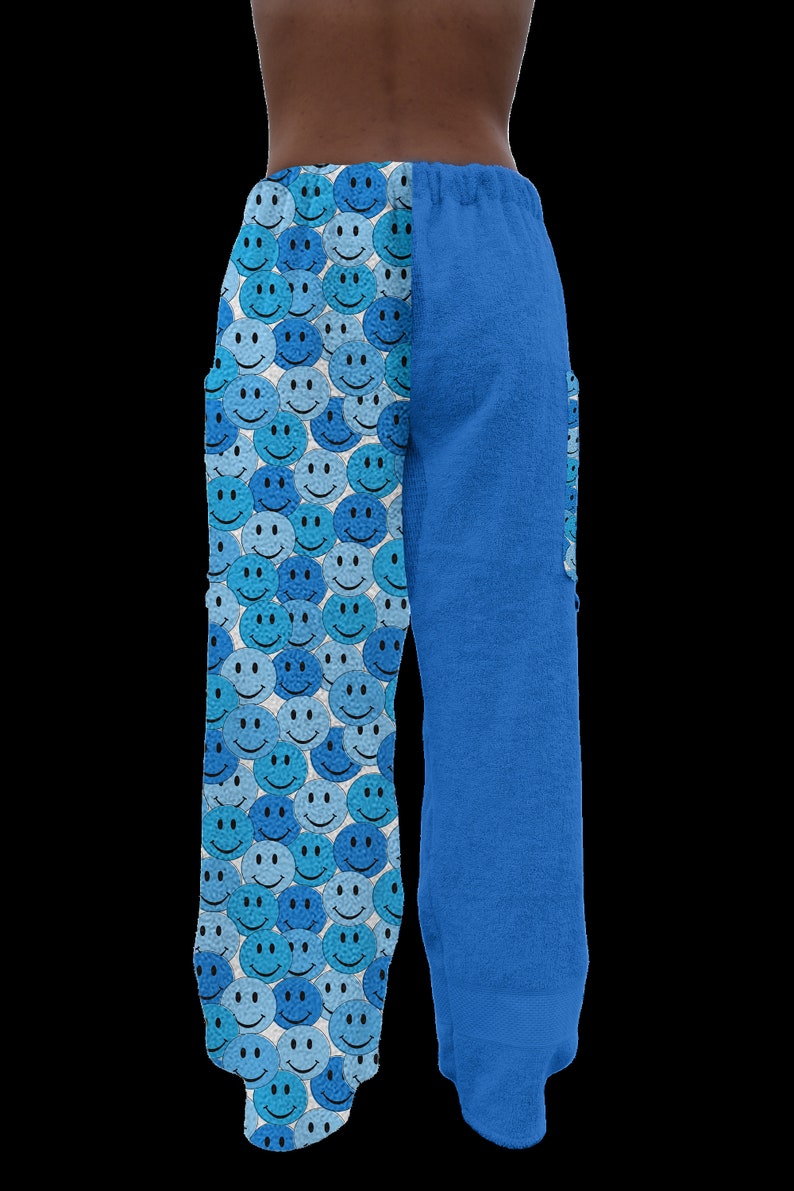 May include: Blue and white patterned pants with a smiley face design on one leg and a solid blue color on the other leg.