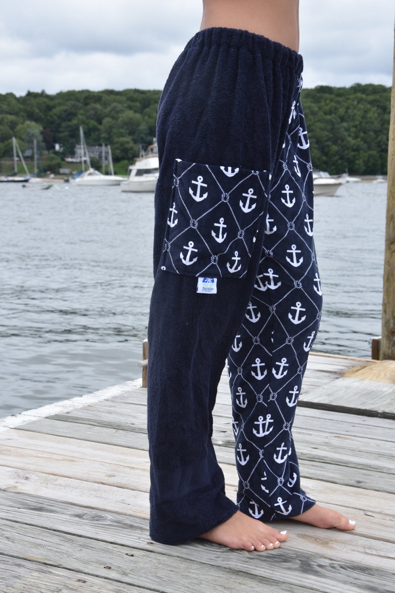 May include: Navy blue terry cloth pants with a white anchor and rope pattern. The pants have a large pocket on the left leg with a white anchor and rope pattern.