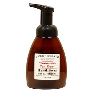 May include: A brown hand soap bottle with a black pump dispenser. The label reads "SWEET SCENTS SOAP COMPANY Cinnamon Tea Tree Hand Soap with Essential Oil 8 oz/227g". The bottle has a curved shape.