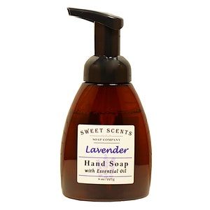 May include: A brown bottle of lavender scented foaming hand soap with a black pump top. The bottle has a label that reads "Sweet Scents Soap Company Lavender Hand Soap with Essential Oil 8 oz/227g".
