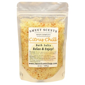 May include: A clear plastic pouch filled with yellow bath salts labeled "Sweet Scents Soap Company Citrus Chill Bath Salts Relax & Enjoy!" with directions and ingredients listed. The pouch contains 12 ounces or 339 grams of bath salts.
