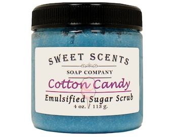 May include: A blue glass jar with a black lid containing a sugar scrub. The label reads "SWEET SCENTS SOAP COMPANY Cotton Candy Emulsified Sugar Scrub 4 oz. 113 g."