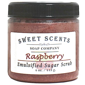 May include: A jar of raspberry-scented sugar scrub, labeled "SWEET SCENTS SOAP COMPANY Raspberry Emulsified Sugar Scrub 4 oz. / 113 g."