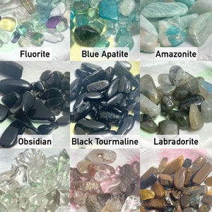 a view of our crystals: fluorite, blue apatite, amazonite, obsidian, black tourmaline, labradorite, clear quartz, phantom quartz, & tigers eye. message us for a more in depth description of each crystal.