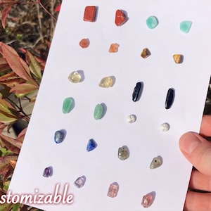 12 pairs of Crystal Stud Earrings on a large white card, a spectrum of rainbow & neutral tones: red jasper, carnelian, citrine, green aventurine, lapis lazuli, amethyst, amazonite, tigers eye, black tourmaline, howlite, labradorite, strawberry quartz