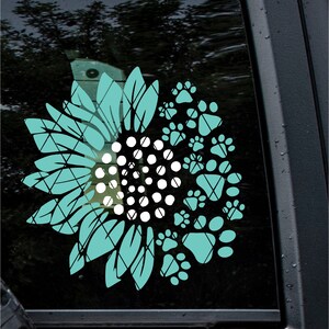 Puede incluir: Girasol azul turquesa con un centro blanco y un borde de huellas de patas. El girasol est&aacute; hecho de un patr&oacute;n a cuadros.