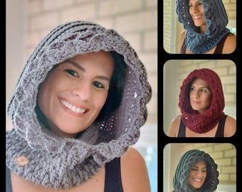 May include: A gray crocheted hood with a scalloped edge and a wooden button closure. The image also shows the hood in blue, burgundy, and green. The hood is designed to be worn around the neck and over the head.