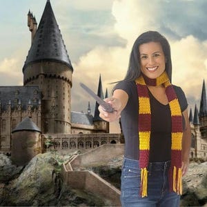 May include: A woman wearing a burgundy and yellow striped scarf and holding a wand, with a castle in the background. The scarf has yellow tassels. The castle has multiple towers and spires.