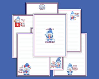 May include: A collection of white stationery sheets with blue horizontal lines and red and blue borders. Each sheet features a cartoon gnome illustration in blue and white winter attire with text including Winter is Gnoming and Hot Cocoa.