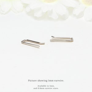 May include: Two silver ear wires, one bent into a U shape and the other straight, are shown on a white surface. Picture showing 1mm earwire. Available in 1mm and 0.8mm earwire sizes.