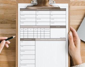 May include: A clipboard with a patient intake form. The form has sections for patient information, in-site notes, assessments, and notes for practitioners. The clipboard is on a wooden table with a laptop computer to the right.