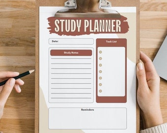 May include: A white study planner on a brown clipboard, a pencil, and a laptop on a wooden surface. The planner has the words "STUDY PLANNER" in brown text with a brown background. The planner has sections for "Date", "Study Notes", "Task List", and "Reminders".