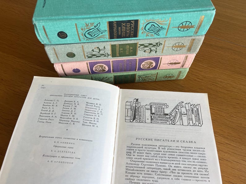 May include: A stack of four vintage hardback books with a teal, pink, and green colour scheme. The top book has the title "Russian Poetry Anthology" in gold lettering. The bottom book is open to a page with a list of authors and a black and white illustration of a bookshelf filled with books.