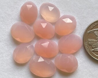 May include: Ten faceted oval-shaped pink chalcedony gemstones. The stones are approximately the size of a UK 20 pence coin.