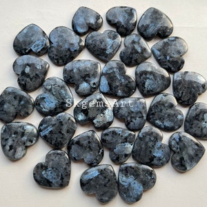 May include: A collection of 25 heart-shaped labradorite stones, each with a unique blue sheen and dark gray color. The stones are polished and smooth, with a variety of sizes and shapes.