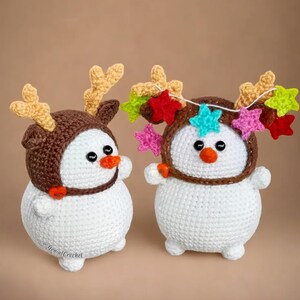 two crocheted snowmen wearing reindeer hats with stars on them