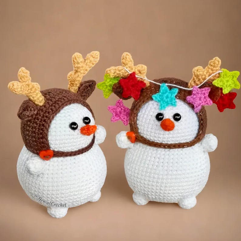 two crocheted snowmen wearing reindeer hats with stars on them