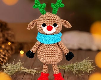 May include: A crocheted reindeer toy with brown fur, green antlers, a blue scarf, a red nose, and red boots.