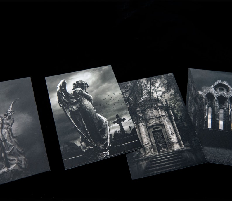 May include: Four black and white photographs of a cemetery. The first image shows a stone angel statue with wings. The second image shows a stone mausoleum with a door and steps. The third image shows a stone cross with a figure on it. The fourth image shows a stone archway with a window.