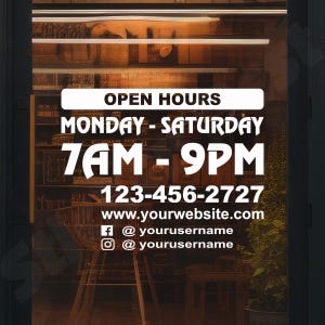 May include: A white vinyl decal for a glass door featuring the text OPEN HOURS, MONDAY - SATURDAY, 7AM - 9PM, 123-456-2727, www.yourwebsite.com, and social media handles @yourusername with Facebook and Instagram icons in a bold font.