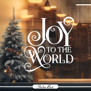 May include: White vinyl decal with the words "Joy to the World" in a decorative script font. The decal is displayed on a storefront window with a Christmas tree in the foreground.