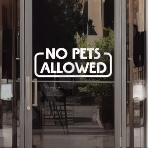 May include: A white sign with black lettering on a glass door that reads "NO PETS ALLOWED".