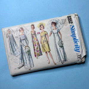 May include: A vintage sewing pattern for a wedding dress, featuring five different styles. The pattern is from Simplicity and is size 14, bust 34. The pattern is printed on a white background with black text and illustrations.