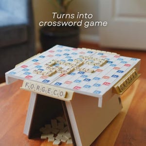 May include: A Scrabble game set up as a crossword puzzle. The game is in a wooden frame with tiles spelling out words. The text "Turns into crossword game" is above the game.
