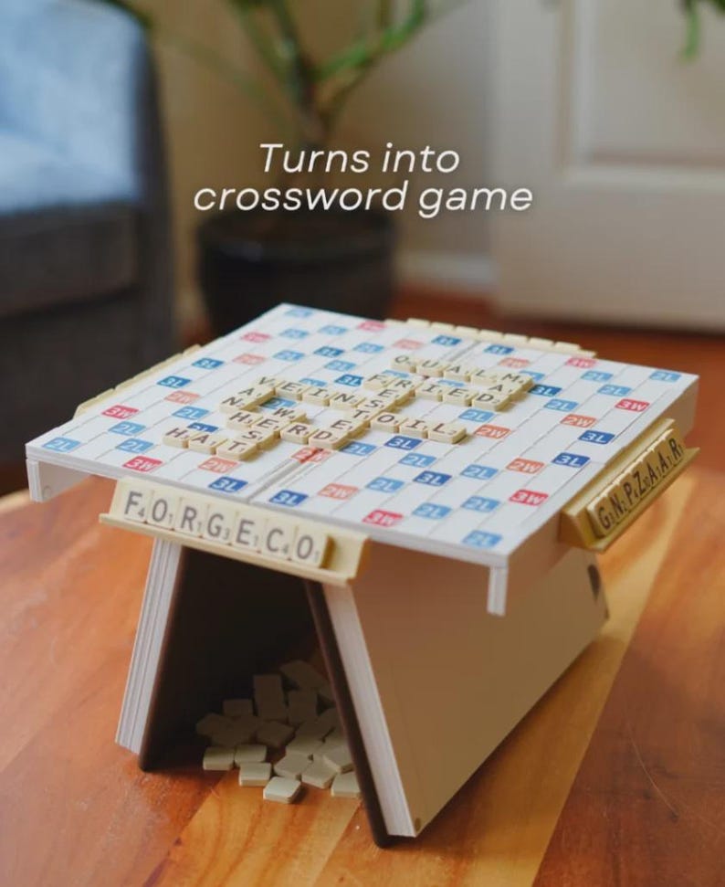 May include: A Scrabble game set up as a crossword puzzle. The game is in a wooden frame with tiles spelling out words. The text "Turns into crossword game" is above the game.