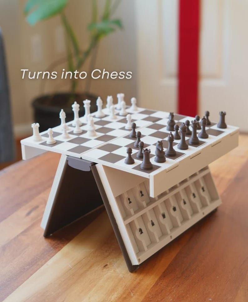 May include: A portable chess set with a brown and white checkered board and black and white chess pieces. The set is open and ready to play, with the text "Turns into Chess" in the upper left corner.
