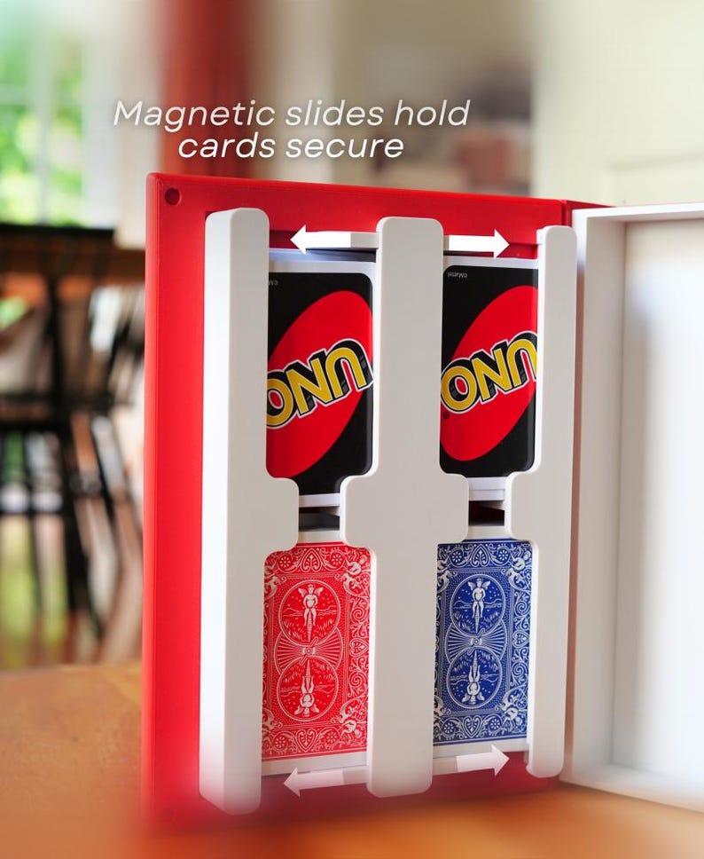 May include: A red card holder with white dividers, holding two Uno cards and two Bicycle playing cards. The text "Magnetic slides hold cards secure" is visible. The holder is designed to keep cards organized.