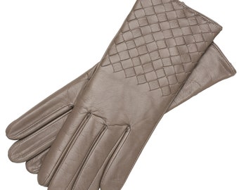 May include: A pair of brown leather gloves with a woven pattern on the back of the hand.