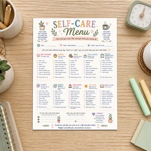 以下が含まれることがあります： 「Self-Care Menu」と書かれた印刷済みのセルフケアプランナーシート。Rest & Recharge、Nourish、Move、Calm & Soothe、Focus & Productivity、Connect、Create & Express、Space & Reset、Joy & Fun、Grow & Learnといったカテゴリーに分けられたウェルネスアクティビティのリストが記載されています。