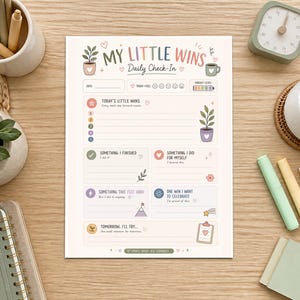 May include: A daily check-in planner sheet titled My Little Wins with sections for date, mood, energy level, and daily accomplishments. The page features pastel-colored illustrations of plants, a coffee mug, and a clipboard, with prompts for tracking small wins and goals.