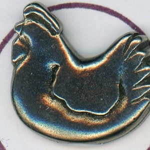 May include: A silver-coloured metal charm in the shape of a chicken. The charm is detailed with a raised design of a chicken with its head turned to the side.