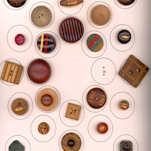 May include: A collection of various wooden buttons in different shapes, sizes, and colors. The buttons include round, square, and barrel-shaped designs, with details like stripes, carved patterns, and inlaid accents. The buttons are displayed on a white background.