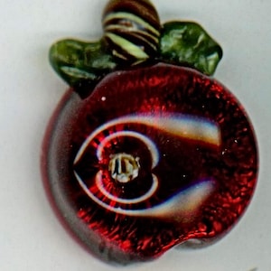 Awesome red apple button with worm hole and the worm on the top of the apple so cute by Mary Gaumond  signed and dated 5/8 x 7/8 NBS medium