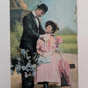 Romantyczna edwardiańska para pocztówka – 1910 ręcznie barwiona zabytkowa karta z różową sukienką, książką i kwiatami – Norwegia używana