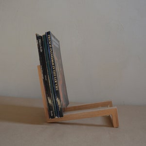 Modern oak magazine rack, minimalist wooden book holder, handcrafted Scandinavian style, natural wood storage stand for books and magazines