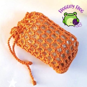 Orange cotton soap saver with drawstring close. Shown with a bar of soap inside.