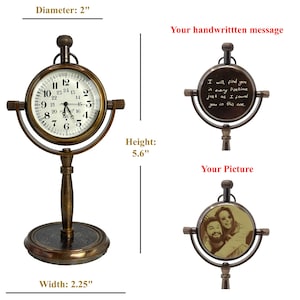 May include: An antique-style brass desk clock with a round face, 2-inch diameter, displaying Roman numerals and hands. The clock is 5.6 inches tall and 2.25 inches wide. The image also shows a space for a handwritten message and a picture.