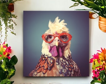 May include: Square canvas art featuring a close-up of a chicken wearing red-rimmed glasses. The chicken has a white and tan feathered head, a purple wattle, and a blue-gray background. The image is surrounded by plants and jars.