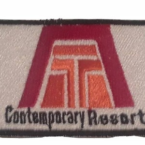 May include: Rectangular patch with a white background and a black border. The patch features a stylized logo in red and orange, with the words "Contemporary Resort" in black text below the logo.