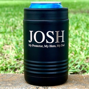 May include: Black insulated can cooler with the name "JOSH" and the text "My Protector, My Hero, My Dad" engraved in silver lettering.
