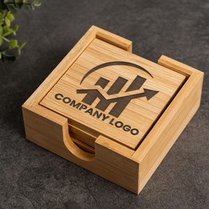May include: A set of square bamboo coasters stacked inside a matching bamboo holder. The top coaster features a dark laser-engraved graphic of a bar chart with an upward-trending arrow and the text COMPANY LOGO centered below the graphic.