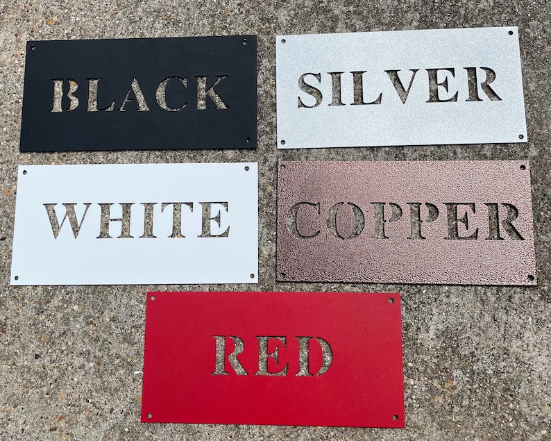 May include: Five metal signs with different colours and the words "BLACK", "SILVER", "WHITE", "COPPER", and "RED" cut out of the metal.